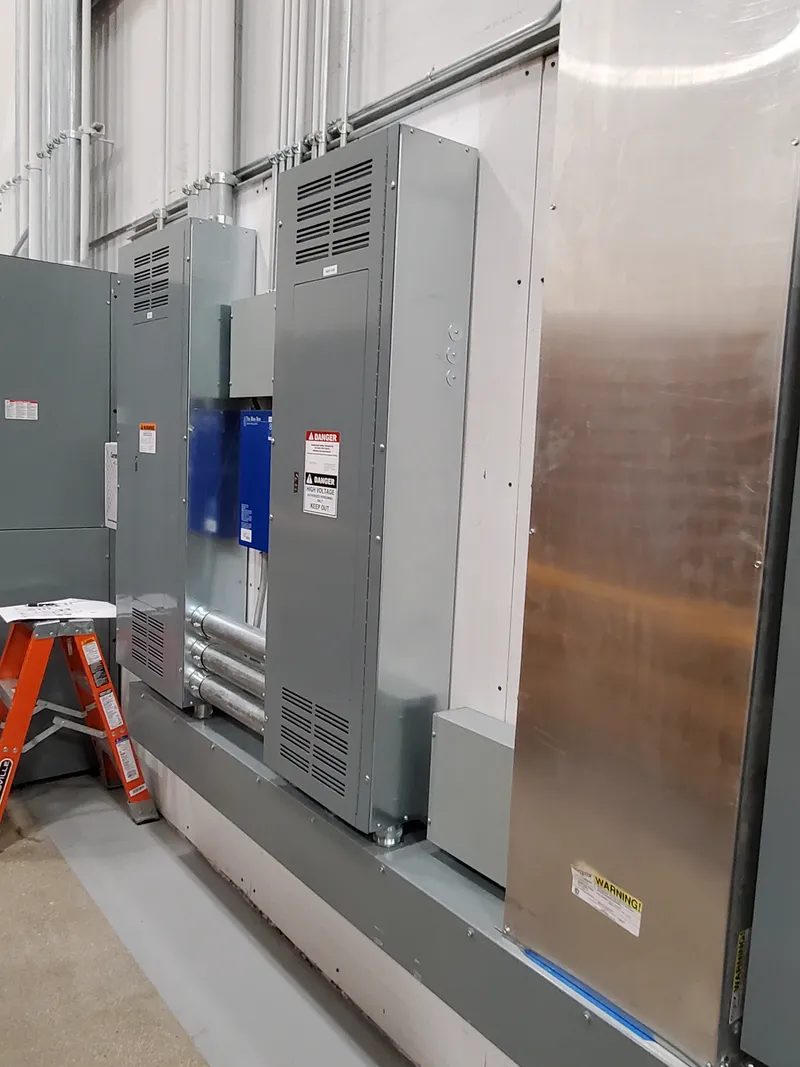 Electrical panel with proper arc flash warning label showing calculated incident energy, arc flash boundary, and PPE requirements per NEC 110.16