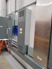 Electrical panel with proper arc flash warning label showing incident energy and PPE requirements