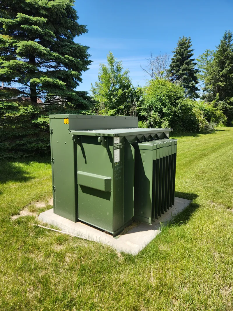 Pad-mount utility distribution transformer whose upgrade can change available fault current and invalidate downstream arc flash labels